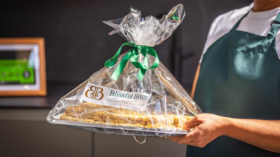 A whole flapjack traybake wrapped in cellophane and tied with a ribbon bow