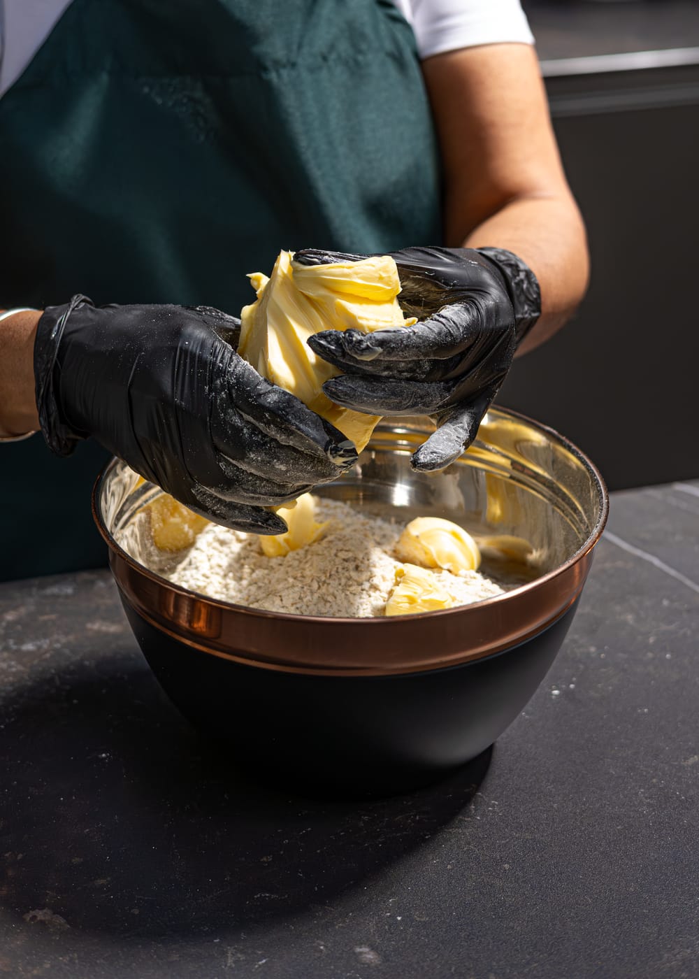 Hand mixing butter into oats for a batch of flapjack